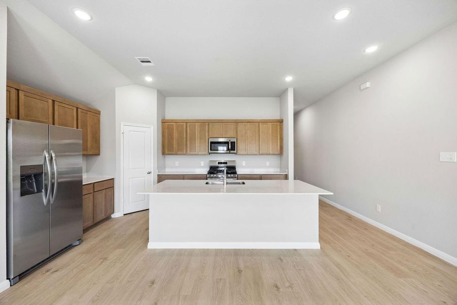 Kitchen in the Sabine home plan by Trophy Signature Homes – REPRESENTATIVE PHOTO