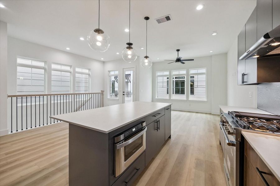 Kitchen-centered layout with oversized island and clear sightlines