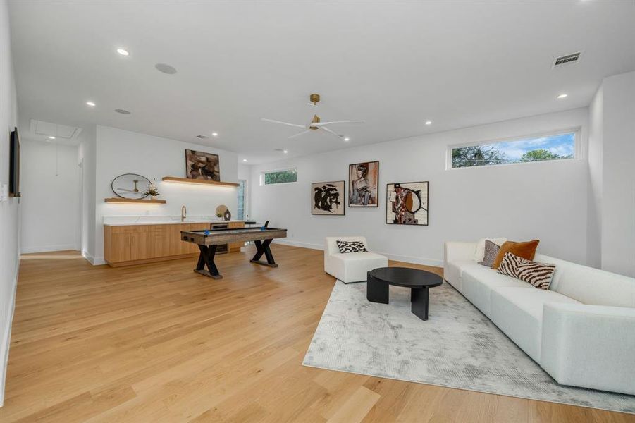 Living area with recessed lighting, light wood-type flooring, a ceiling fan, attic access, and billiards Living area with recessed lighting, light wood-type flooring, a ceiling fan, attic access, and billiards