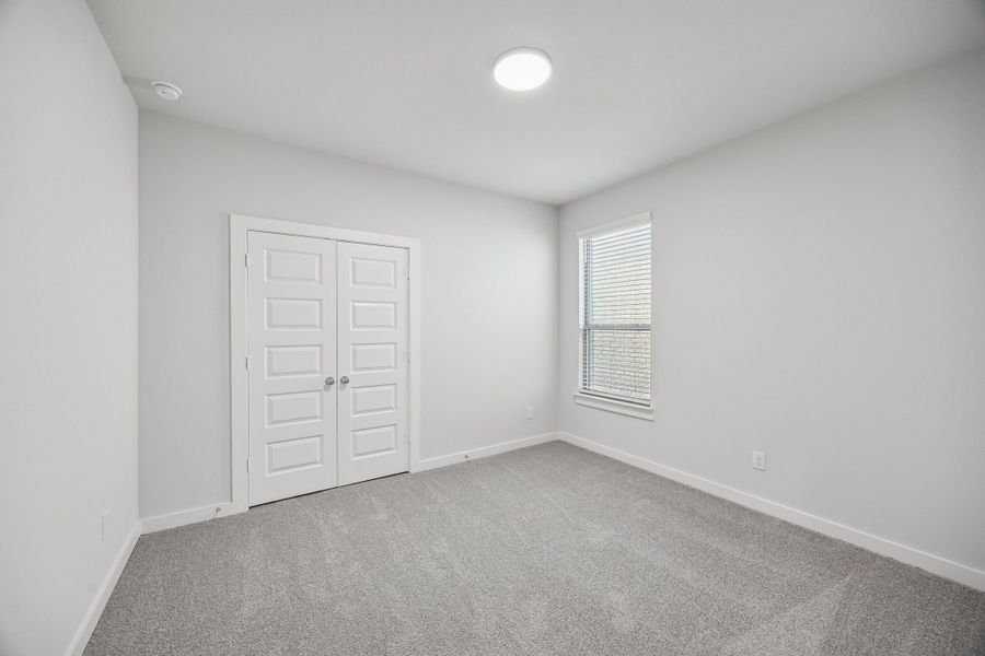 Bedroom in the Wimbledon home plan by Trophy Signature Homes – REPRESENTATIVE PHOTO