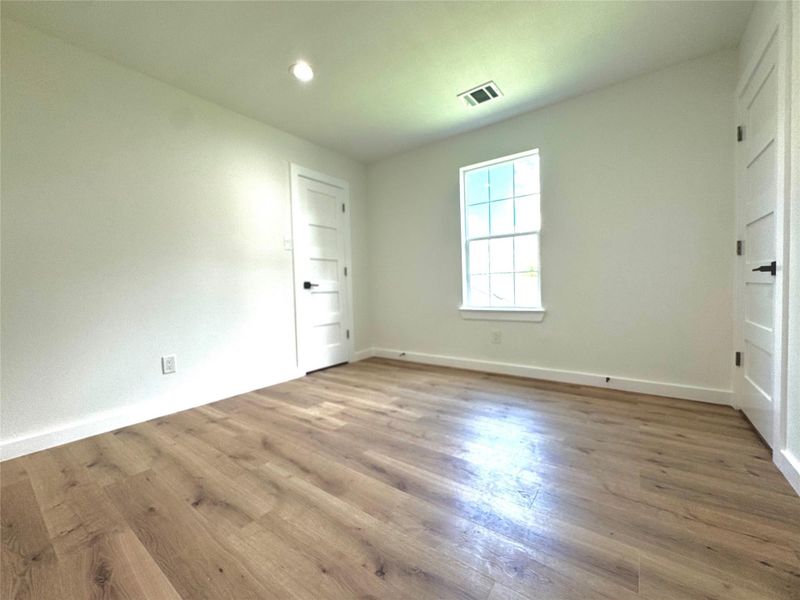 Second bedroom with walk-in closet to the left and entrance to Jack and Jill bathroom on the right. Second bedroom with walk-in closet to the left and entrance to Jack and Jill bathroom on the right.