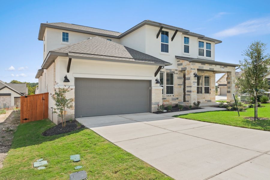 Front exterior of a new home in Lariat, Liberty Hill, TX, highlighting curb appeal (Image 26).