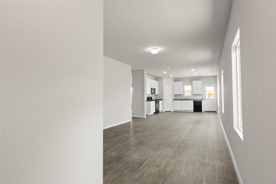 Unfurnished living room with dark wood-style floors and recessed lighting Unfurnished living room with dark wood-style floors and recessed lighting