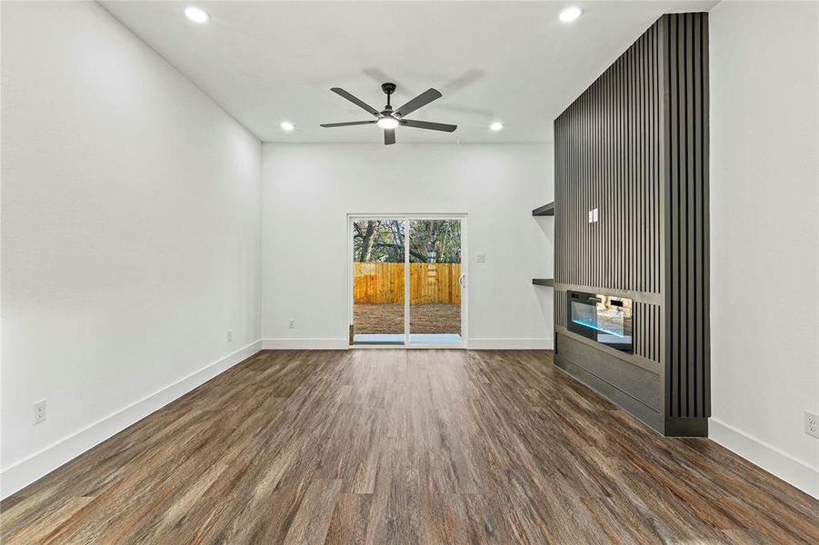 Unfurnished living room with dark wood-style flooring, recessed lighting, and a ceiling fan