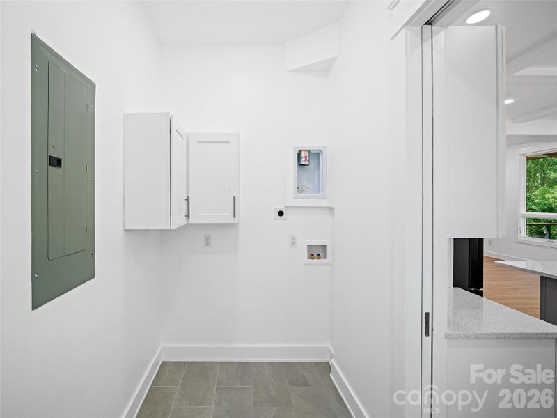Laundry room with stacking unit supplies.