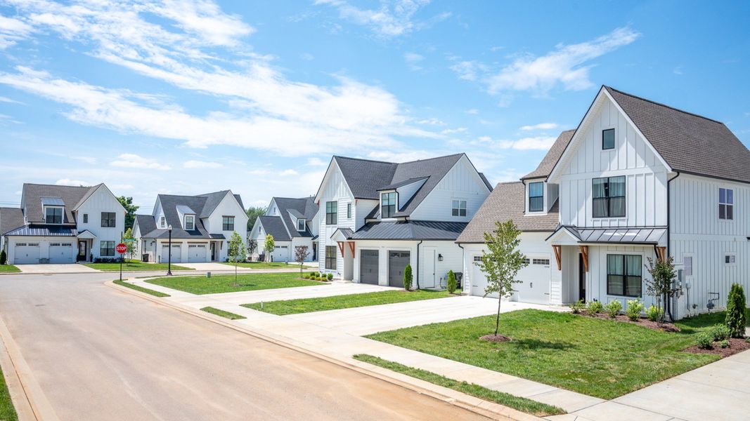 Front exterior with white siding and 2-car garage