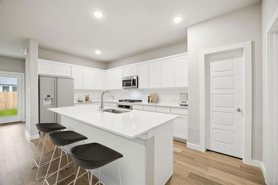 Kitchen in the Oscar home plan by Trophy Signature Homes – REPRESENTATIVE PHOTO
