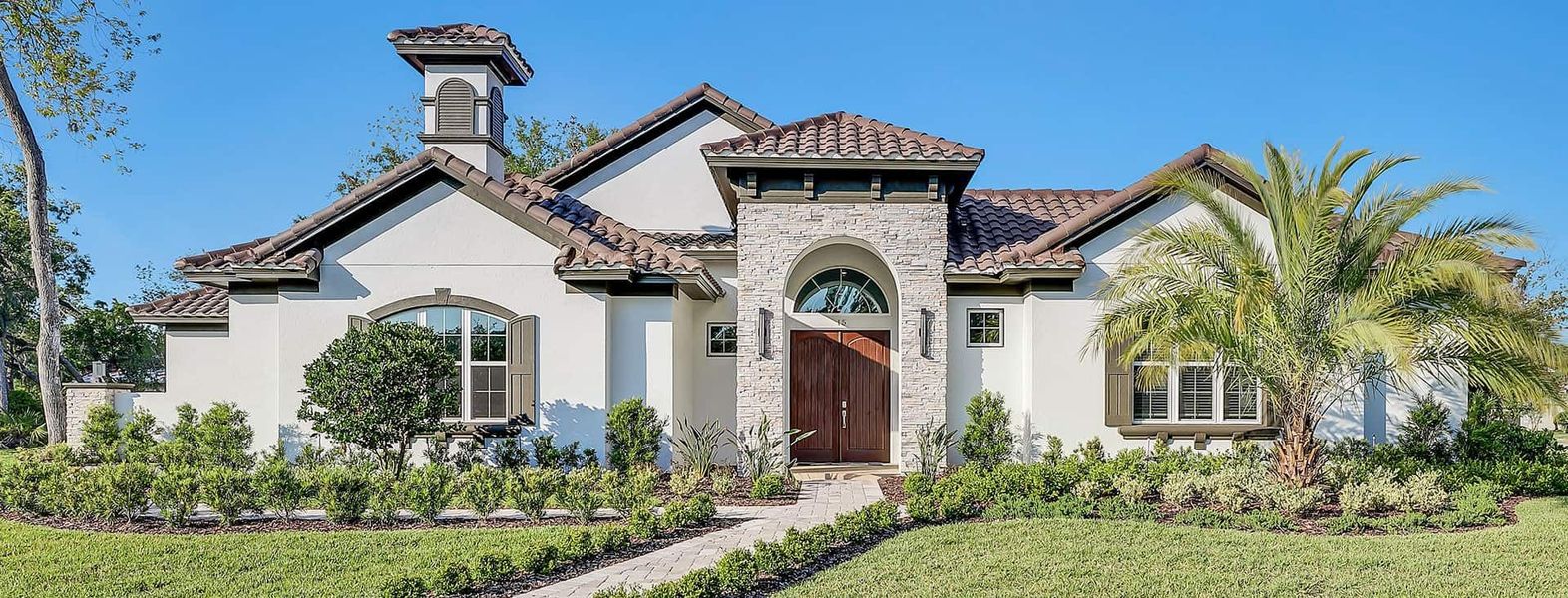 Front exterior of a new home in Toscana, Palm Coast, FL, highlighting curb appeal (Image 1). Front exterior of a new home in Toscana, Palm Coast, FL, highlighting curb appeal (Image 1).