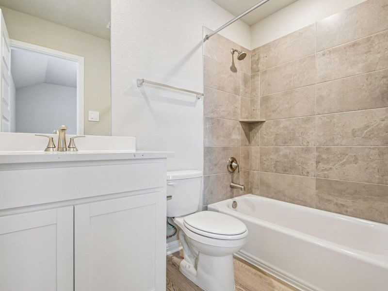 Bathroom featuring wood finished floors, bathtub / shower combination, and vanity Bathroom featuring wood finished floors, bathtub / shower combination, and vanity