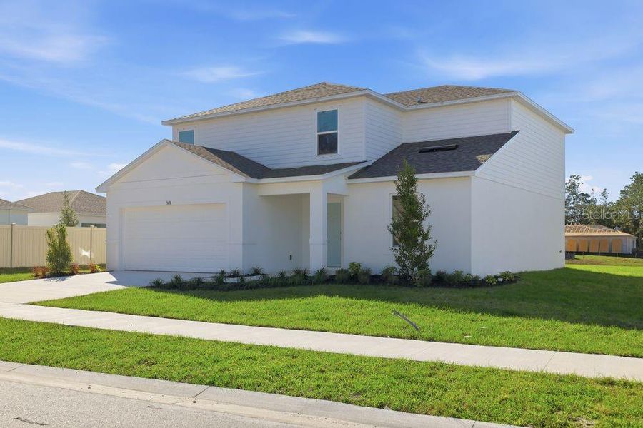 Front exterior of a new home in Palm Wind, Hudson, FL, highlighting curb appeal (Image 23).