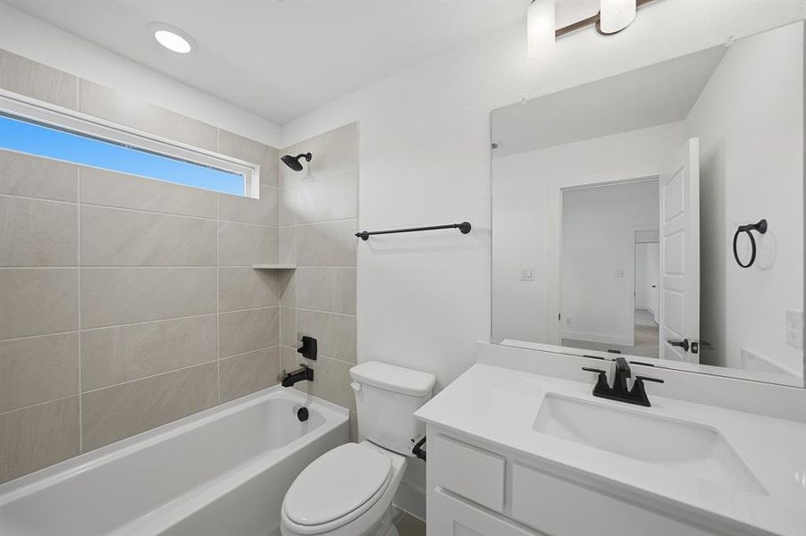 Full bathroom featuring vanity and bathtub / shower combination Full bathroom featuring vanity and bathtub / shower combination