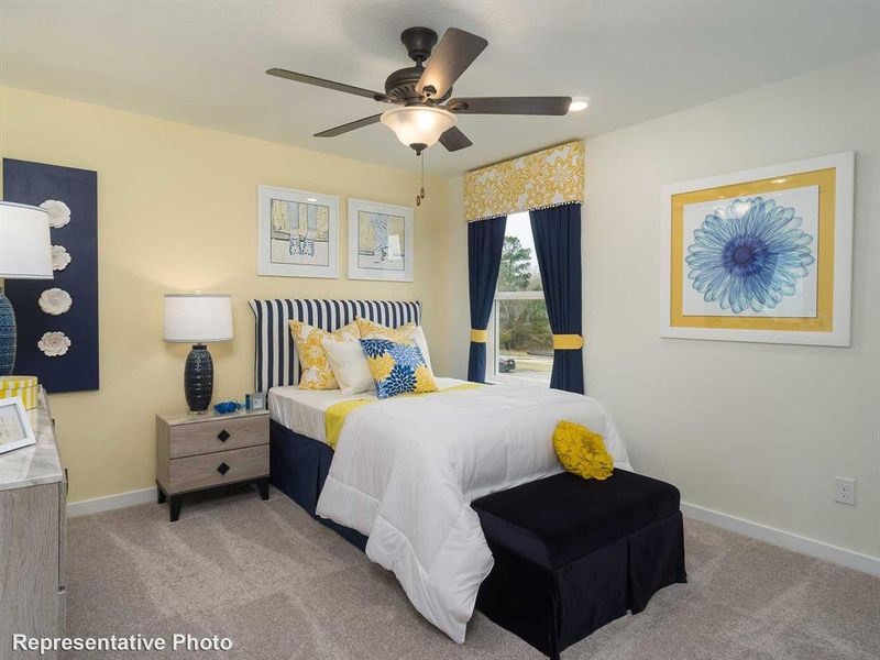 Carpeted bedroom featuring baseboards and a ceiling fan
