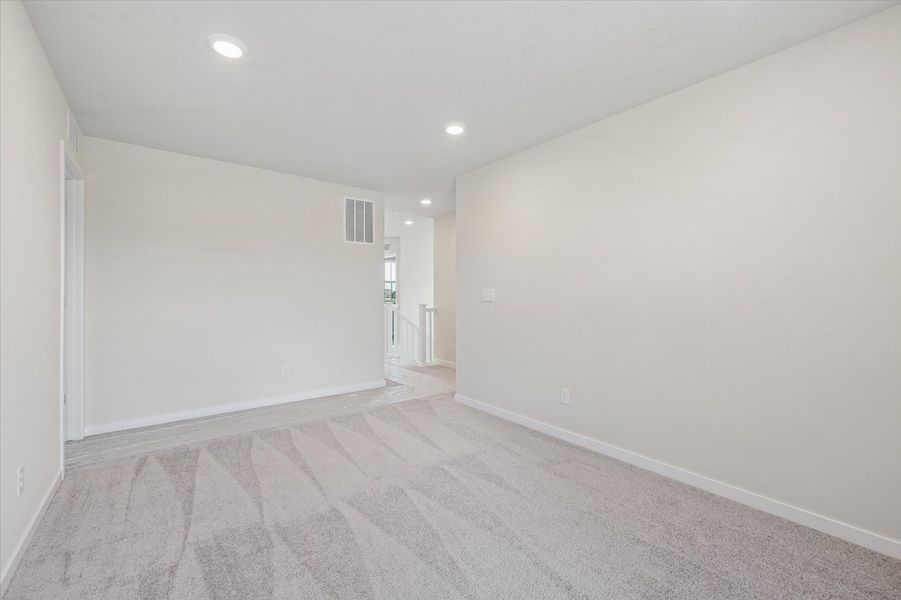 A long hallway with white walls.