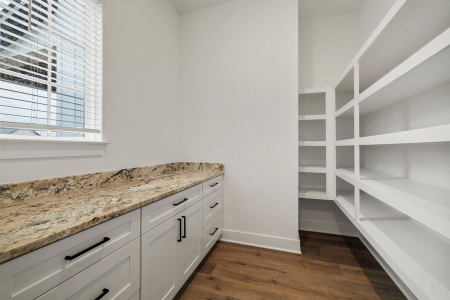 The walk-in pantry with built in shelves and counterspace. The walk-in pantry with built in shelves and counterspace.
