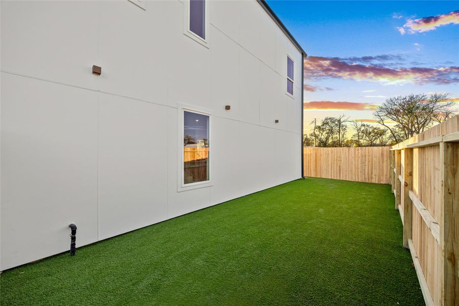 View of side of home with a fenced backyard