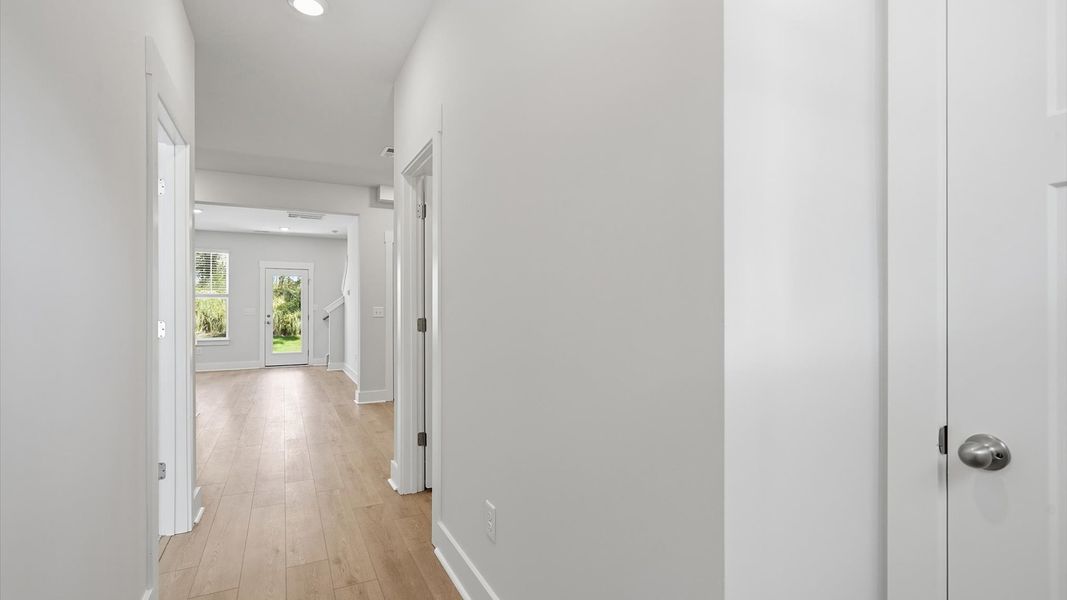 Highly functional foyer with hardwood flooring that flows seamlessly into living spaces by DRB Homes Highly functional foyer with hardwood flooring that flows seamlessly into living spaces by DRB Homes