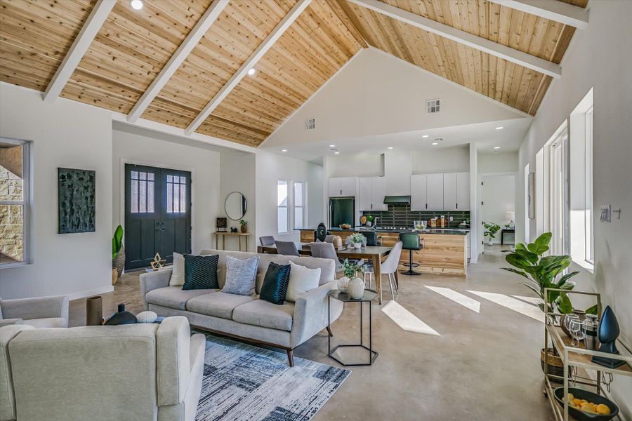 Living area with a wood ceiling with exposed beams, high vaulted ceiling, concrete flooring, and recessed lighting