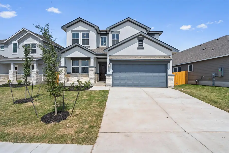 Front exterior of a new home in Butler Farms, Liberty Hill, TX, highlighting curb appeal (Image 1). Front exterior of a new home in Butler Farms, Liberty Hill, TX, highlighting curb appeal (Image 1).