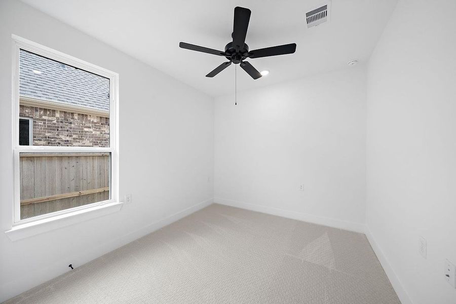 Representative unfurnished interior of a home built from the Cardinal by Caldwell Homes in Chambers Creek, Willis (Image 24).