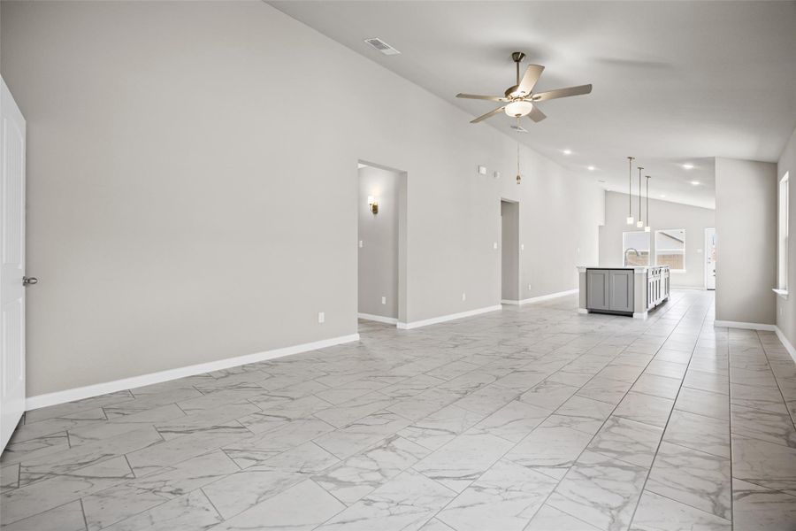 Gleaming tile floors sweep through this expansive, airy living space with vaulted ceilings. Gleaming tile floors sweep through this expansive, airy living space with vaulted ceilings.