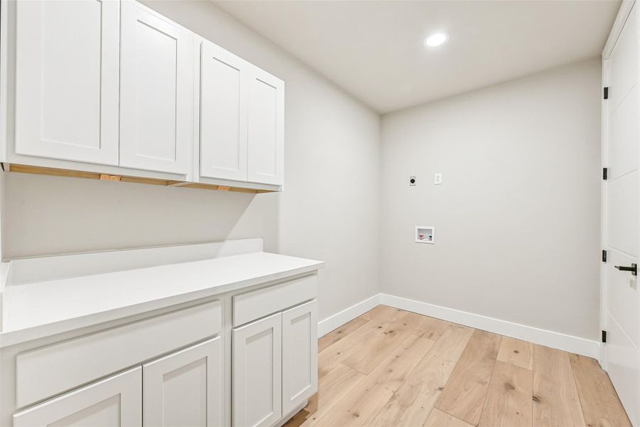 Bright, organized, and designed for efficiency, the laundry area makes everyday tasks feel effortless. Clean finishes and built in storage continue the home’s elevated design throughout.