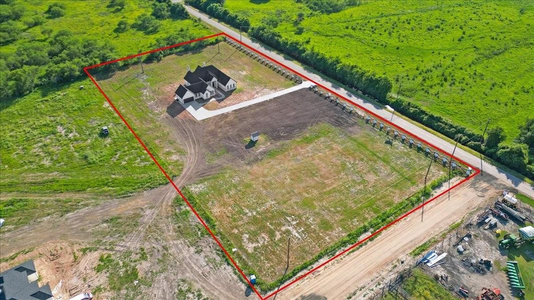Bird's-eye view of the property showcasing the expansive lot and surrounding landscape. Bird's-eye view of the property showcasing the expansive lot and surrounding landscape.