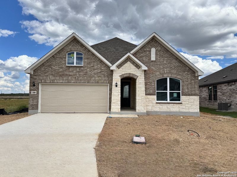 Front exterior of a new home in Megan's Landing 50's, Castroville, TX, highlighting curb appeal (Image 1). Front exterior of a new home in Megan's Landing 50's, Castroville, TX, highlighting curb appeal (Image 1).