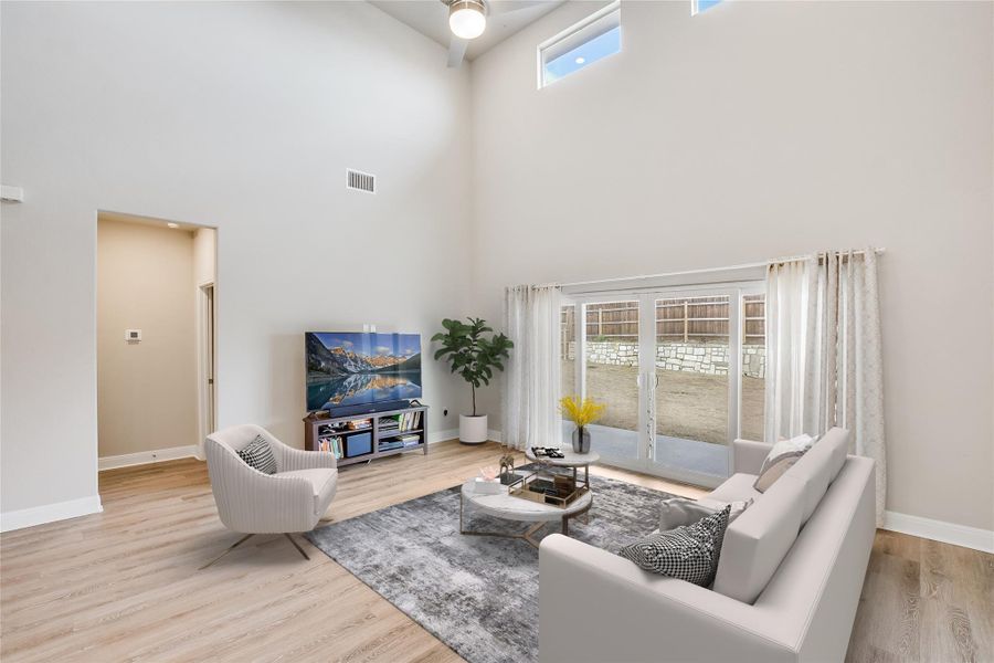 Living room with french doors, visible vents, baseboards, and wood finished floors