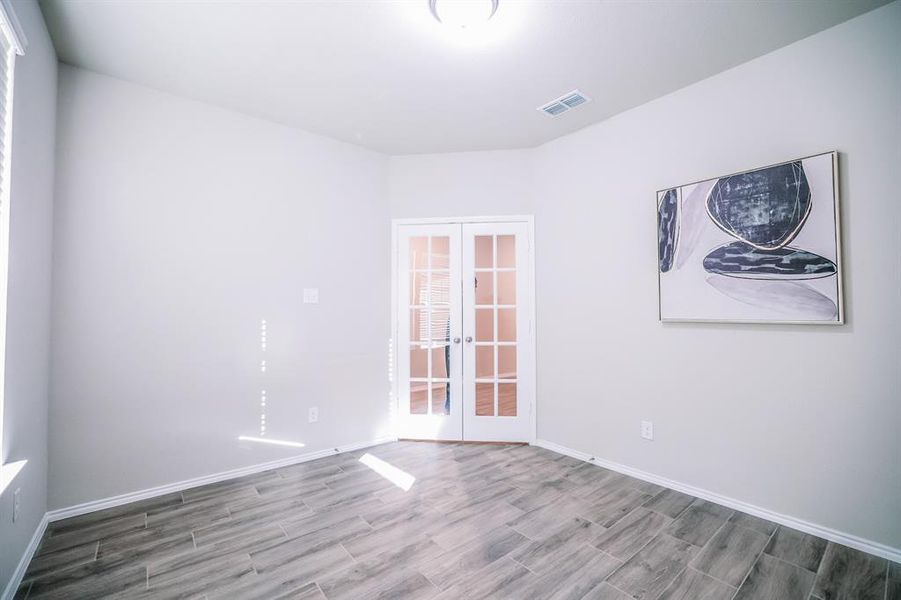 Unfurnished room with french doors