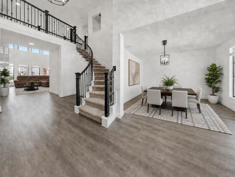 Elegant hardwood flooring flows through this home's airy living spaces, complementing the grand staircase and formal dining room. Elegant hardwood flooring flows through this home's airy living spaces, complementing the grand staircase and formal dining room.