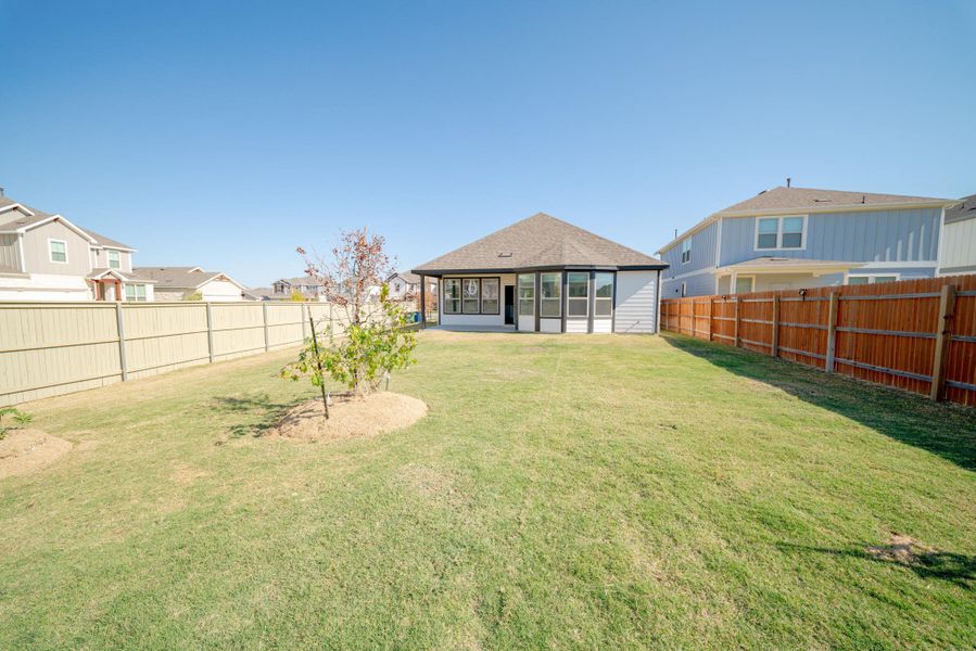 Fenced backyard with a residential view Fenced backyard with a residential view