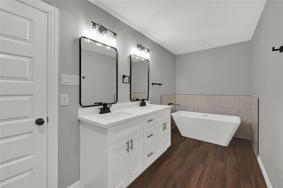 Primary Bathroom with dual vanity and free standing tub