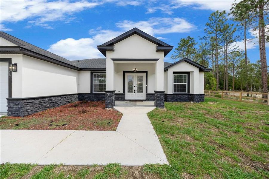 Front exterior of a new home in , Dunnellon, FL, highlighting curb appeal (Image 1). Front exterior of a new home in , Dunnellon, FL, highlighting curb appeal (Image 1).