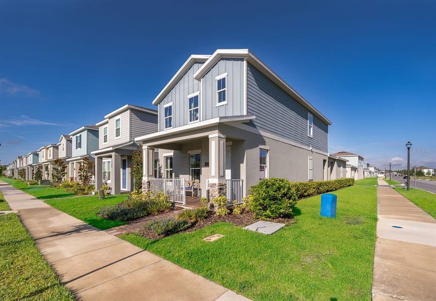 Front exterior of a new home in Serenade at Ovation, Winter Garden, FL, highlighting curb appeal (Image 20).