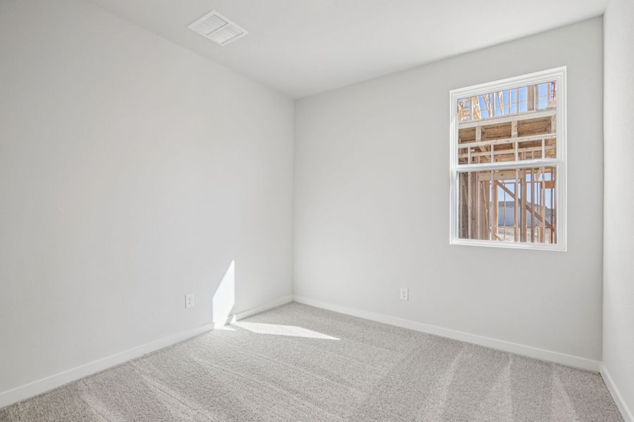 A room with a window and a rug. A room with a window and a rug.