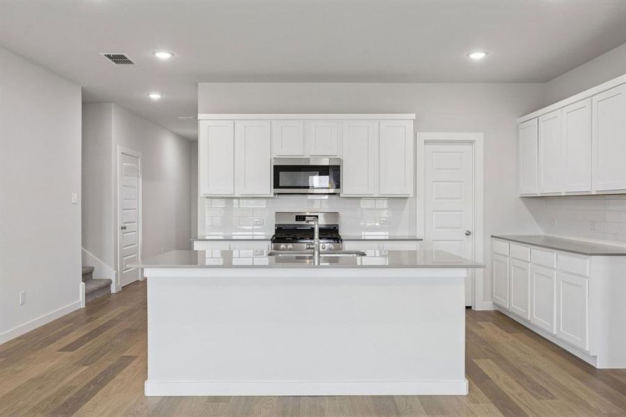 Kitchen in the Masters home plan by Trophy Signature Homes – REPRESENTATIVE PHOTO