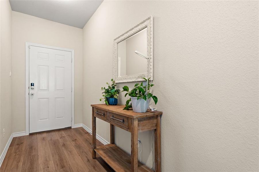 Foyer featuring wood finished floors and baseboards
