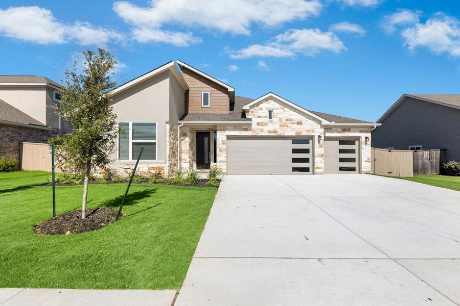 Front exterior of a new home in The Colony, Bastrop, TX, highlighting curb appeal (Image 21).