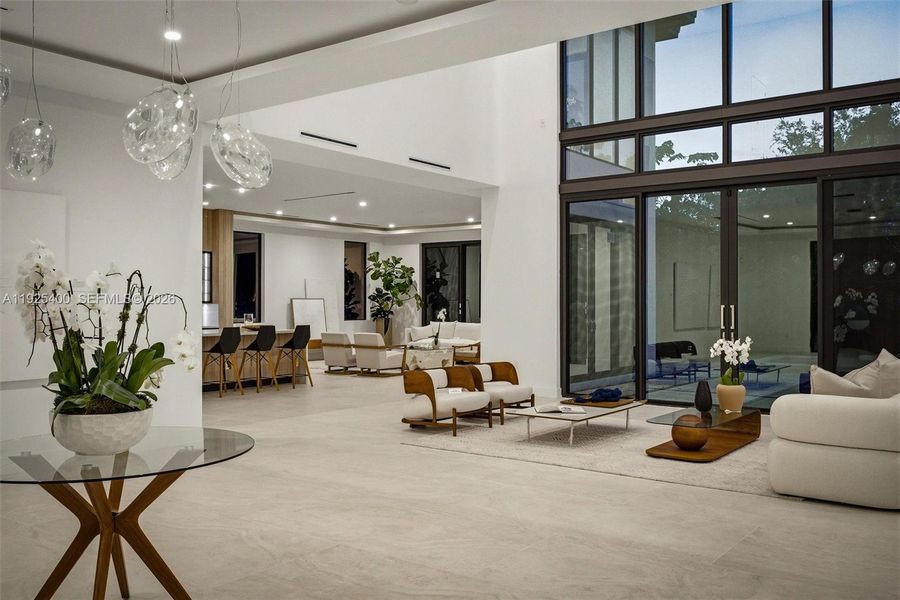 Open-Concept Living Room | Double-Height Glass Wall | Designer Pendants | Pinecrest FL Open-Concept Living Room | Double-Height Glass Wall | Designer Pendants | Pinecrest FL