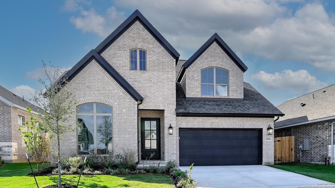 Front exterior of a new home in Meadows Of Mill Creek 50', Seguin, TX, highlighting curb appeal (Image 2).