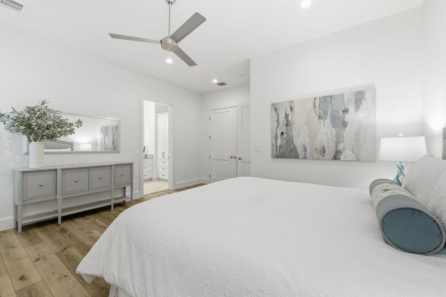 Bedroom featuring light wood-style floors, a ceiling fan, and recessed lighting