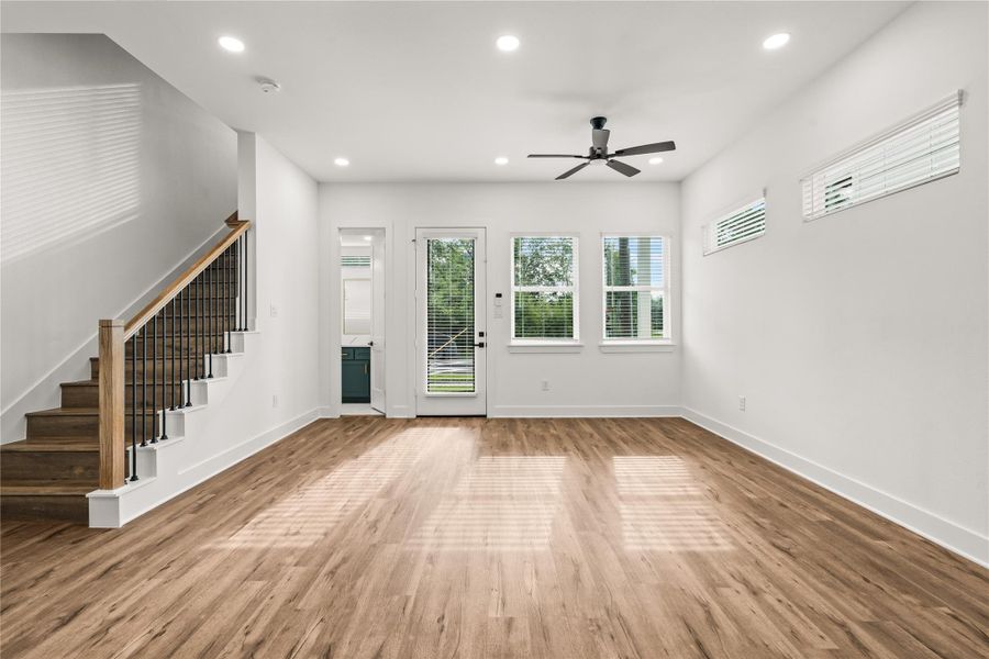 Architectural elegance on display. The modern staircase with sleek iron spindles serves as a beautiful backdrop to your main living zone.