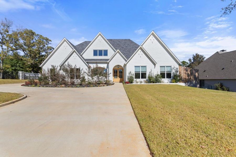 Tudor-style house with a front yard and brick siding