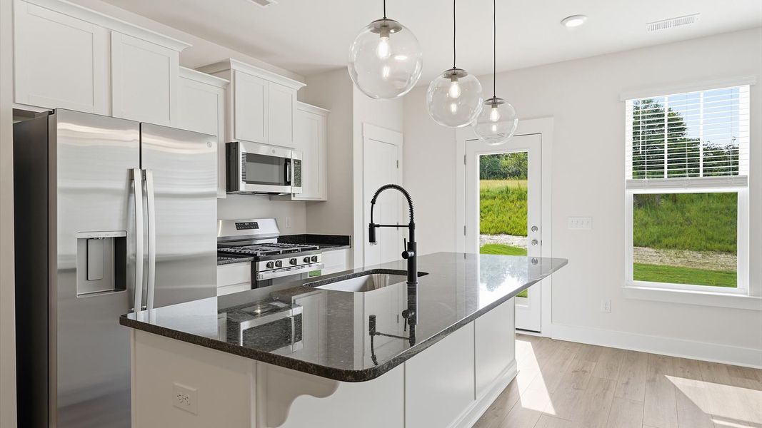 Accomplished design in a kitchen that blends function and form with a right-sized island at Marion Square Accomplished design in a kitchen that blends function and form with a right-sized island at Marion Square