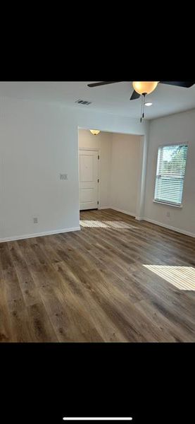 Living room featuring ceiling fan and wood-type flooring