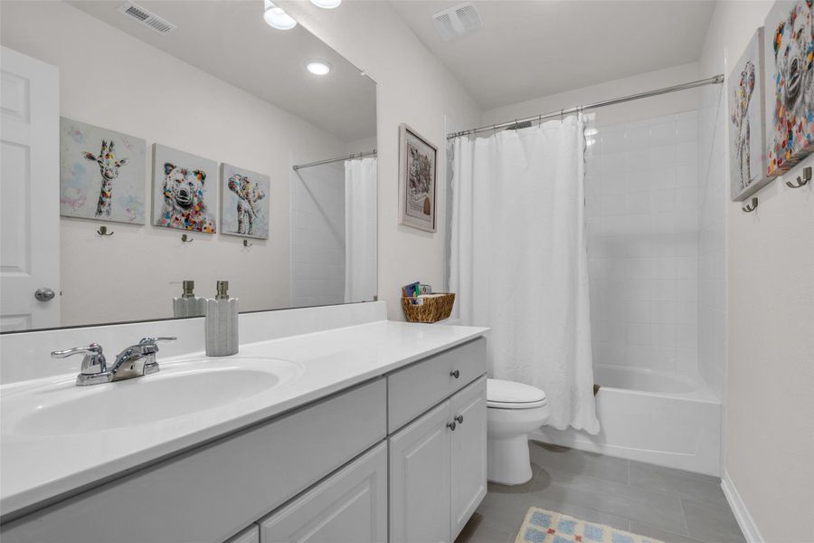 Conveniently serving the bedrooms and living spaces on the second floor, this well-appointed bathroom features a tub and shower combination, providing flexibility for both quick showers and relaxing baths.