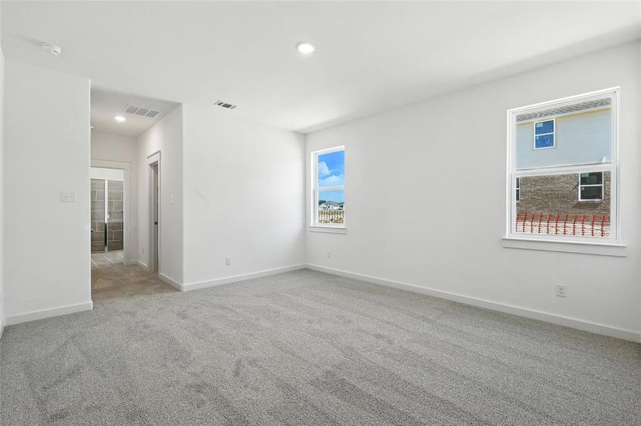 Spare room with light colored carpet and recessed lighting Spare room with light colored carpet and recessed lighting