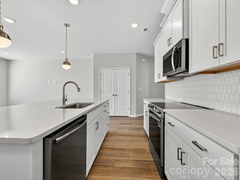 Shiplap Island- Quartz countertops, 42" cabinets with soft close doors and drawers, tiled backsplash, solid shelving in pantry, Frigidaire gallery appliances. cooking is vented to the outside