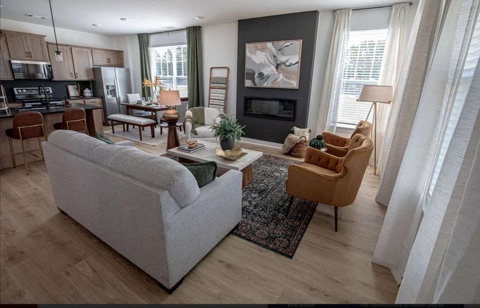 Living area featuring light wood-type flooring and a large fireplace