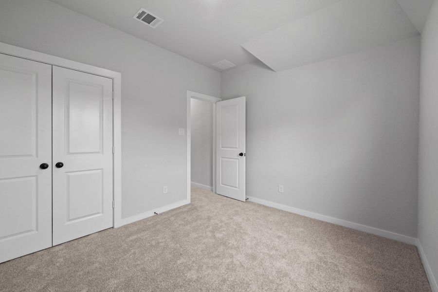 Secondary bedroom with a door with access for easy access to your attic space. Secondary bedroom with a door with access for easy access to your attic space.